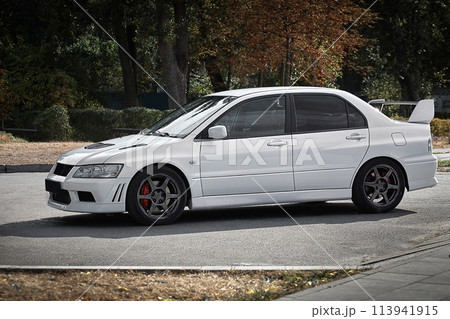 White car on a street background. Modern city sport car with a spoiler wallpaper White car on a street background. Modern city sport car with a spoiler wallpaper 113941915
