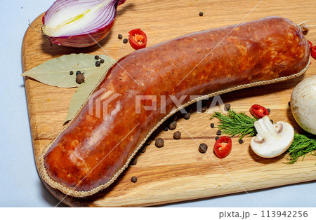 Tasty sausages and vegetables isolated over solid background Tasty sausages and vegetables isolated over solid background 113942256