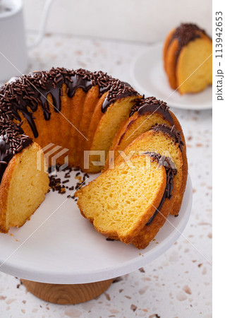 Orange pound cake with dark chocolate ganache and sprinkles 113942653