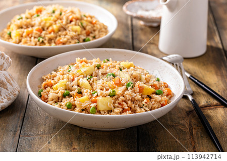 Pineapple fried rice with peas and carrots Pineapple fried rice with peas and carrots 113942714