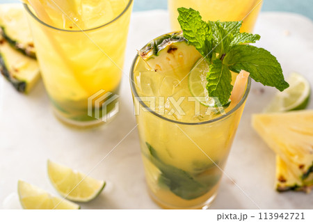Pineapple mojito with limes and mint and a slice of pineapple 113942721