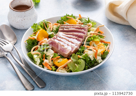 Asian salad with seared tuna sliced on top Asian salad with seared tuna sliced on top 113942730