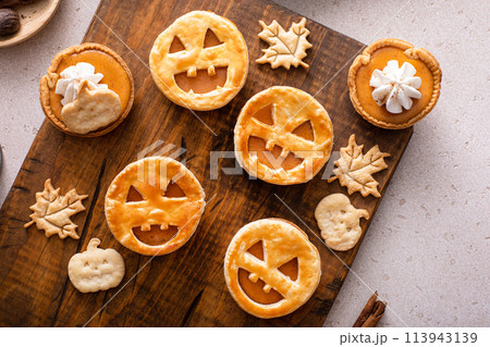 Mini pumpkin pies with jack o lanterns decoration 113943139