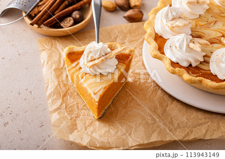 Pumpkin pie with cheesecake swirl, dessert variation for Thanksgiving Pumpkin pie with cheesecake swirl, dessert variation for Thanksgiving 113943149