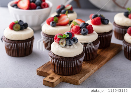 Chocolate cupcakes with cream cheese frosting and fresh berries Chocolate cupcakes with cream cheese frosting and fresh berries 113943153