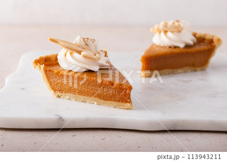 Traditional pumpkin pie for Thanksgiving with whipped cream 113943211