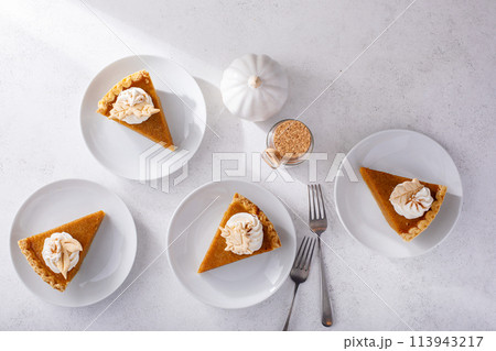 Traditional pumpkin pie for Thanksgiving with whipped cream Traditional pumpkin pie for Thanksgiving with whipped cream 113943217