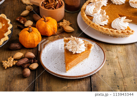 Traditional pumpkin pie for Thanksgiving with whipped cream Traditional pumpkin pie for Thanksgiving with whipped cream 113943344