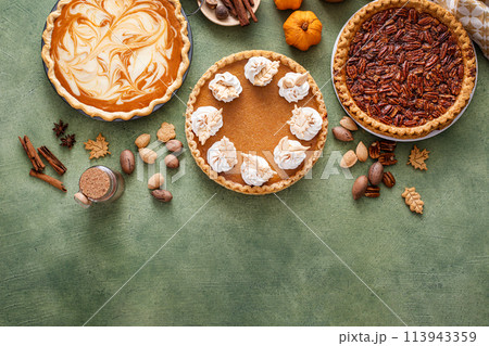 Traditional Thanksgiving pies with pumpkin pie in the middle 113943359