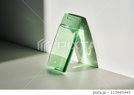 Shower gel or shampoo on a white background with sun light. Shower gel or shampoo on a white background with sun light. 113943445