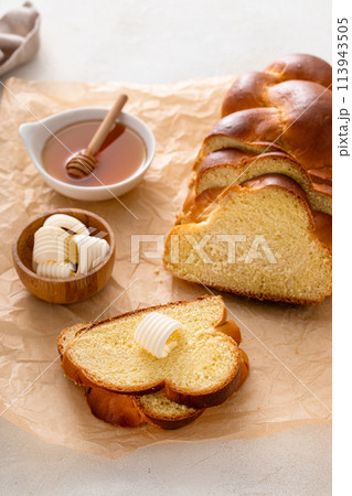 Freshly baked hallah sliced with butter and honey 113943505