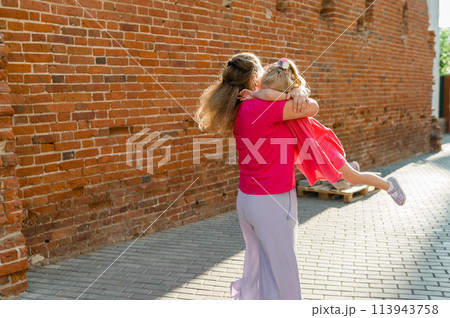 Mother holds and have fun her child with hearing aids and cochlear implants summer outdoor . Deaf and health concept. Diversity and Inclusion and people with disability concept. Copy space 113943758