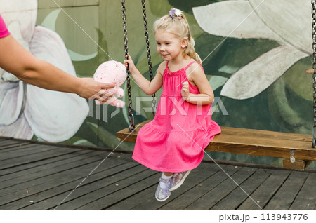 Funny baby with cochlear implant walks outdoor. Hearing aid and medicine innovating technology concept. Diversity and Inclusion and people with disability concept. 113943776
