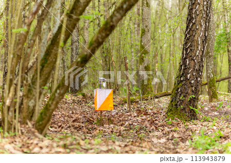 Orienteering. Control point Prism and electric composter for orienteering in the spring forest. 113943879