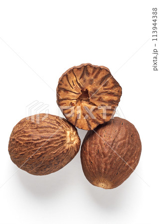 Three textured nutmegs isolated on a white background. Spices for cooking Three textured nutmegs isolated on a white background. Spices for cooking 113944388