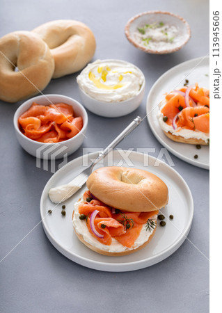 Plain bagel with salmon and cream cheese with fresh dill and capers Plain bagel with salmon and cream cheese with fresh dill and capers 113945606