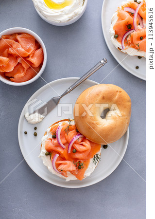 Plain bagel with salmon and cream cheese with fresh dill and capers 113945616