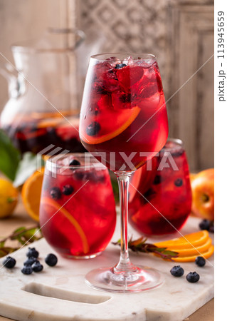 Refreshing summer berry sangria with apples, oranges and blueberry 113945659