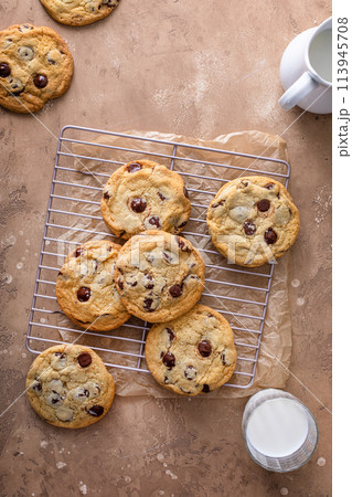 Chocolate chip cookies with flaky salt on a cooling rack 113945708