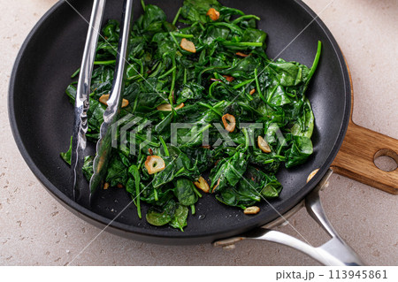 Sauteed spinach with garlic in a skillet Sauteed spinach with garlic in a skillet 113945861