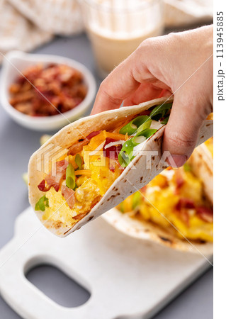 Breakfast tacos with hash browns, eggs and bacon 113945885