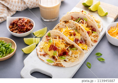 Breakfast tacos with hash browns, eggs and bacon 113945887