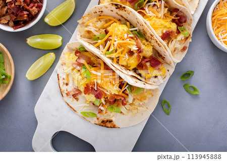 Breakfast tacos with hash browns, eggs and bacon 113945888