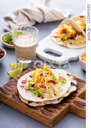 Breakfast tacos with hash browns, eggs and bacon 113945889