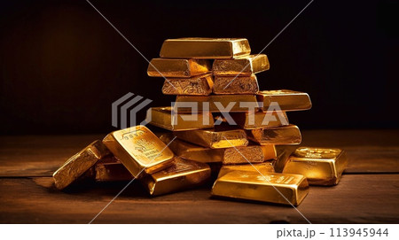 A pile of gold bars on a wooden table. 113945944