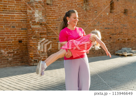 Child girl with cochlear implant with her mother spend time outdoor. Hear impairment and deaf community concept. Deaf and health concept. Disability and inclusion. Copy space 113946649