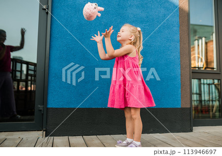 Child with hearing problem and cochlear implant dance in street, deaf kid began to hear. Hearing loss in childhood and treatment concept. Copy space and empty place for text. Inclusion and disability 113946697