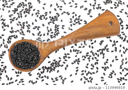 black sesame seeds in wooden spoon isolated on white background. Top view. Flat lay black sesame seeds in wooden spoon isolated on white background. Top view. Flat lay 113946919