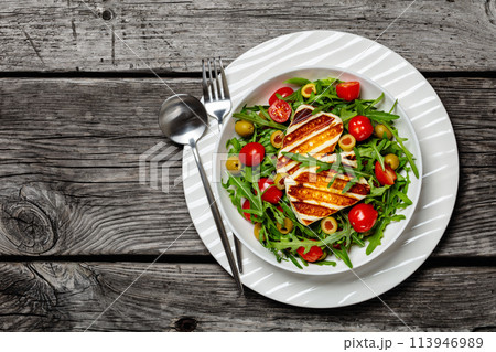 salad with grilled halloumi greek cheese in bowl 113946989