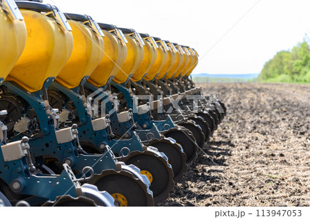A tractor sows a field with grain. 113947053
