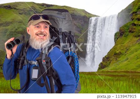 bearded man traveler with tourist equipment and binoculars in hand  113947915