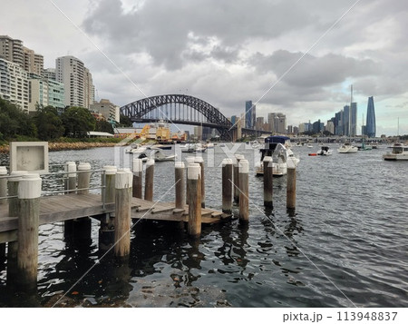 Sydney's harbour foreshore set against the famous Sydney Harbour bridge on a cloudy overcast day 113948837