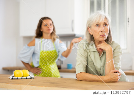 Aggrieved elderly woman having quarrel with her daughter Aggrieved elderly woman having quarrel with her daughter 113952797