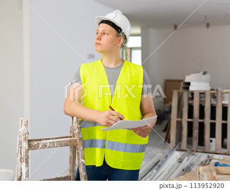 Teenager boy inspecting building site inside apartment 113952920