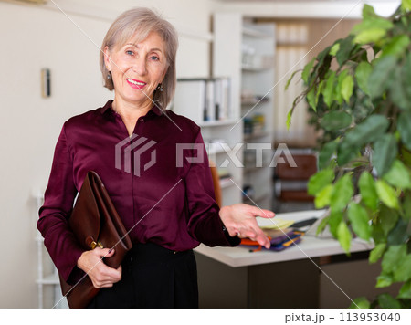 Businesswoman with briefcase for documents in office Businesswoman with briefcase for documents in office 113953040