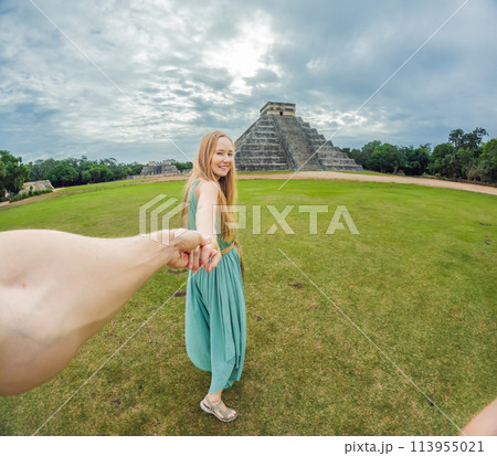Beautiful tourist woman observing the old pyramid and temple of the castle of the Mayan architecture known as Chichen Itza these are the ruins of this ancient pre-columbian civilization and part of 113955021