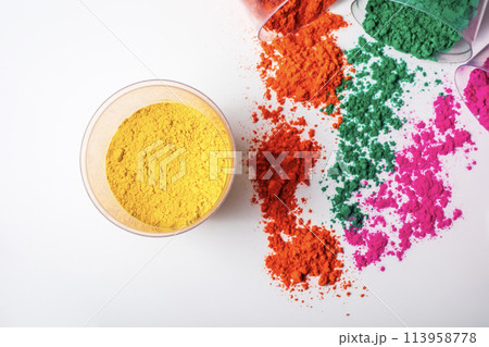 Colorful holi powder in a glass bowl on a white background. Colorful holi powder in a glass bowl on a white background. 113958778