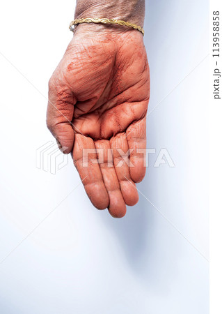 Hands of an Indian woman with red holi powder applied on hand isolated on white background. Hands of an Indian woman with red holi powder applied on hand isolated on white background. 113958858