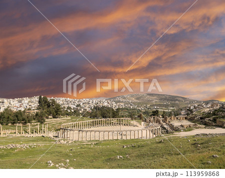 Forum (Oval Plaza) in Gerasa (Jerash), Jordan. Was built in the first century AD. Against the background of a beautiful sky with clouds. 113959868
