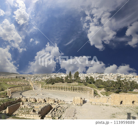 Forum (Oval Plaza) in Gerasa (Jerash), Jordan. Was built in the first century AD. Against the background of a beautiful sky with clouds. Forum (Oval Plaza) in Gerasa (Jerash), Jordan. Was built in the first century AD. Against the background of a beautiful sky with clouds. 113959889