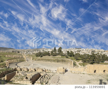Forum (Oval Plaza) in Gerasa (Jerash), Jordan. Was built in the first century AD. Against the background of a beautiful sky with clouds. Forum (Oval Plaza) in Gerasa (Jerash), Jordan. Was built in the first century AD. Against the background of a beautiful sky with clouds. 113959891