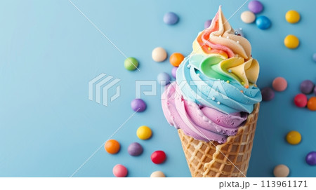 Ice cream cone with rainbow swirl and candy 113961171