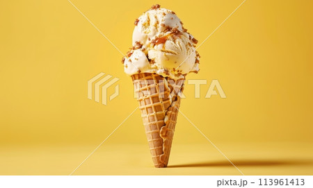 Caramel Ice Cream in Waffle Cone on Yellow Background 113961413