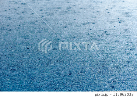 water surface in the pool with raindrops 113962038