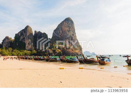 Boats and rocky mountains at Railay beach in evening 113963958