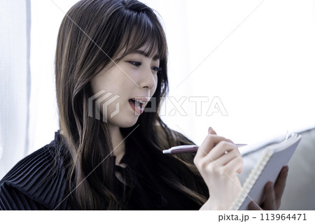 メモをとる若い女性 113964471